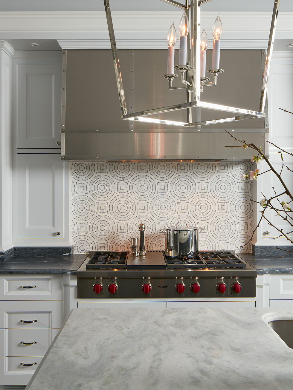 On the backsplash is a beautiful mosaic creating a modern circular pattern using natural stone. / Photo: Nathan Kirkman