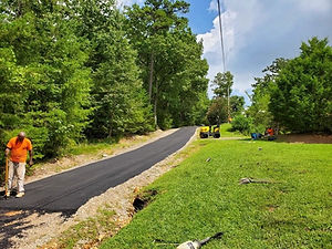Long driveway being paved with asphalt