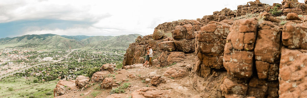 Couple pose in front of foothills in Golden, CO engagement session