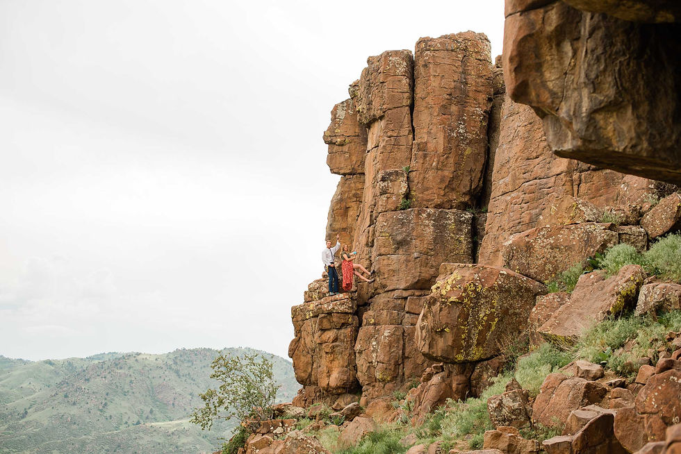 Couple scale rock face in Golden, CO