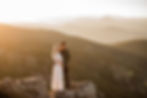 Man and woman overlook the foothills during sunset engagement session in Boulder, CO