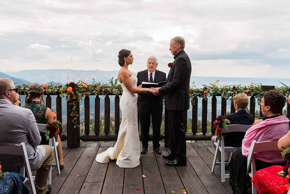 The bride and groom stand at the altar together at Cloud Camp at the Broadmoor