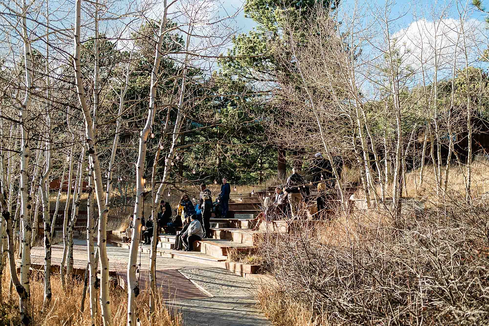 Wedding attendees gather in the ceremony area at the Wild Basin Lodge