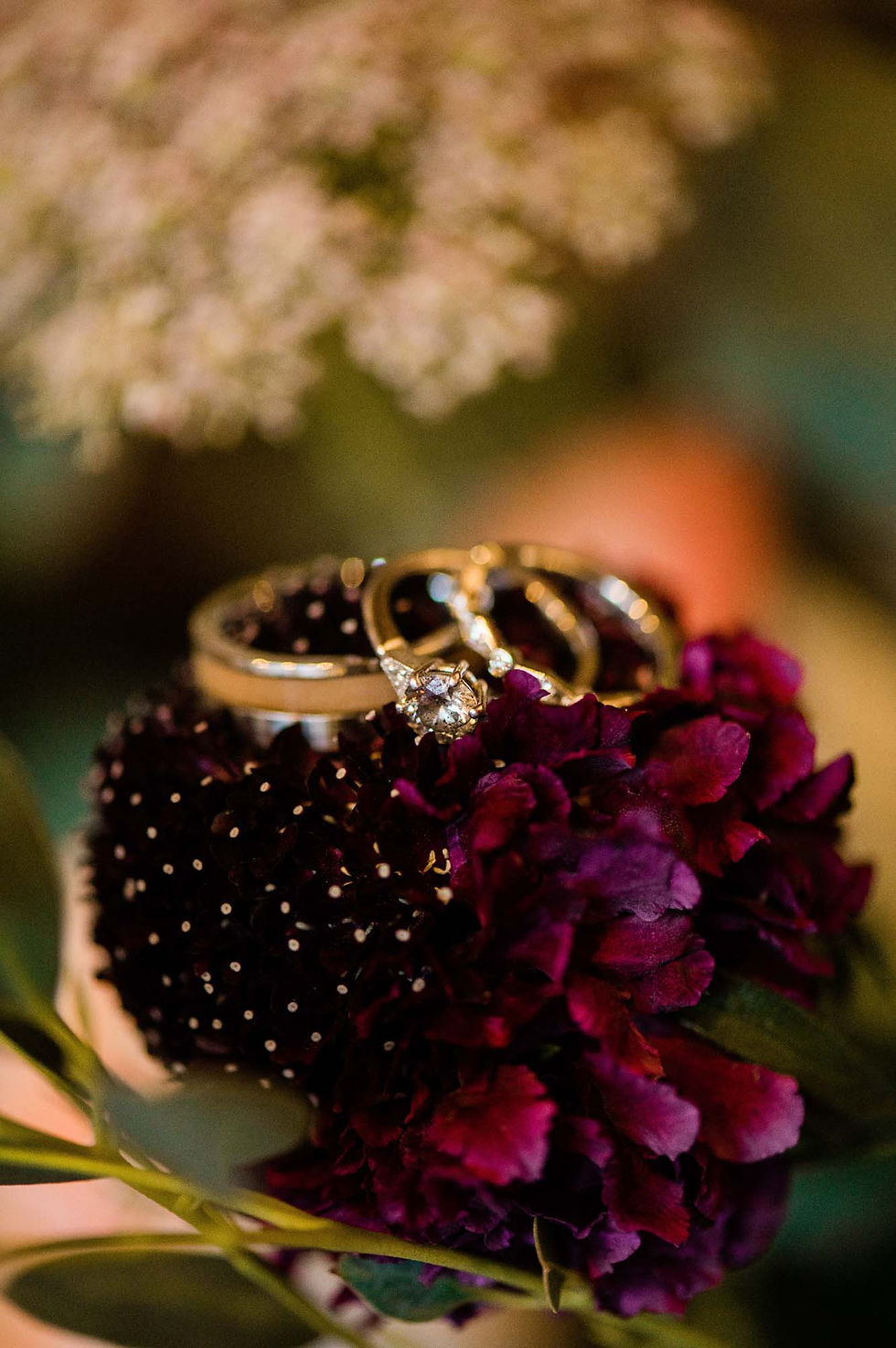 Wedding rings atop the wedding bouquet