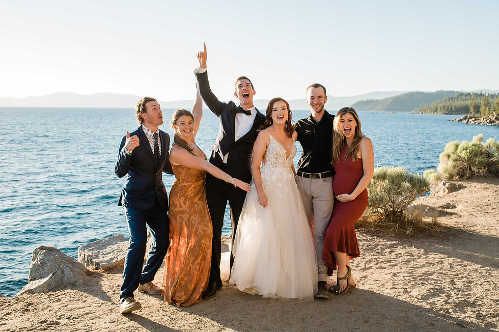 The bride and groom pose with their friends on Lake Tahoe