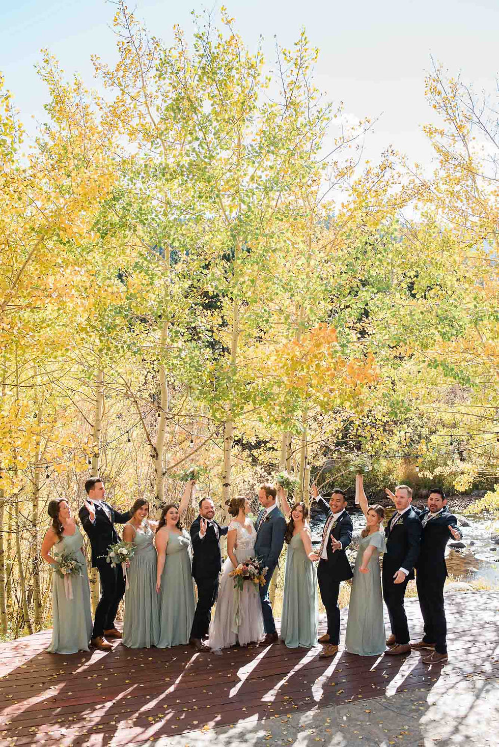 Wedding party poses under aspen trees at the Wild Basin Lodge