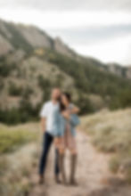 Man and woman pose on NCAR trail during Boulder, CO sunset engagement session