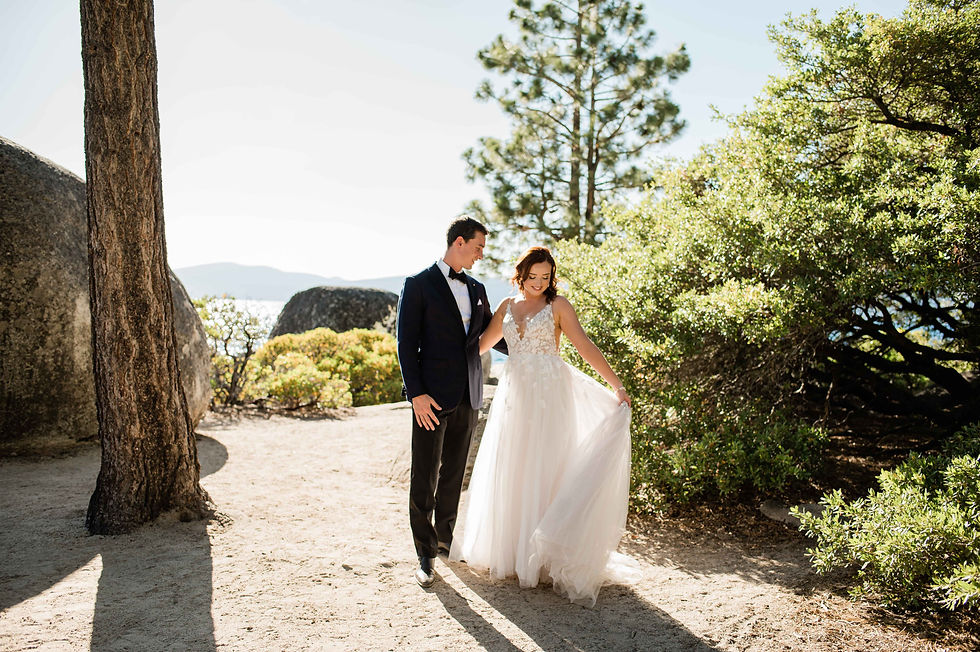 Bride shows off her wedding dress to the groom on Lake Tahoe