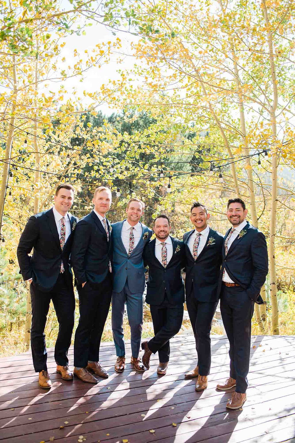Groomsmen pose under the aspen trees at the Wild Basin Lodge