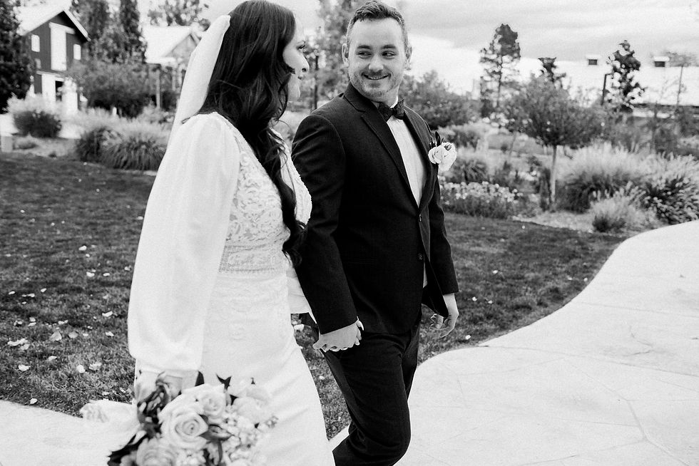 Bride and groom smile at each other as they leave the ceremony