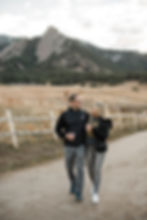 Man and woman walk down trail together at Chautauqua Park in Boulder, CO