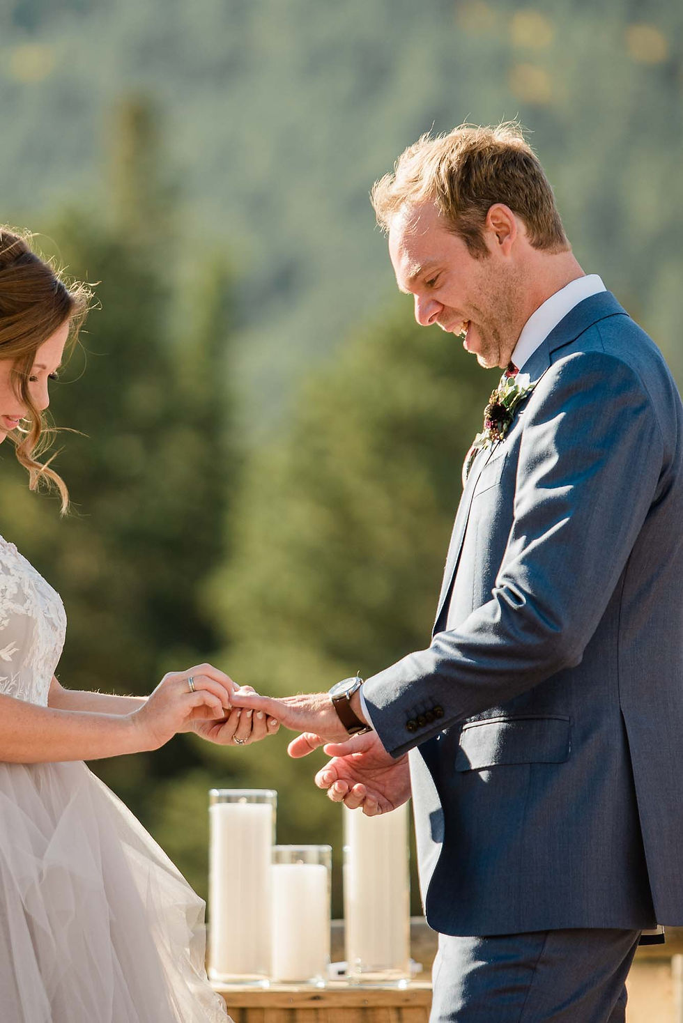 Bride places ring on groom's finger