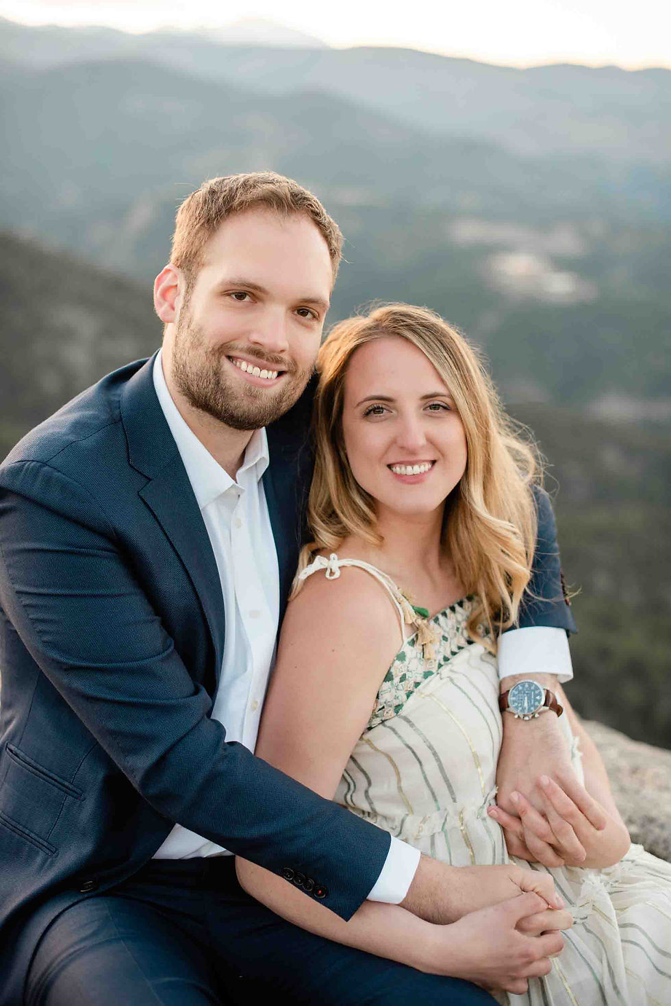 A man and woman hug each other on Flagstaff Mountain in Boulder, CO