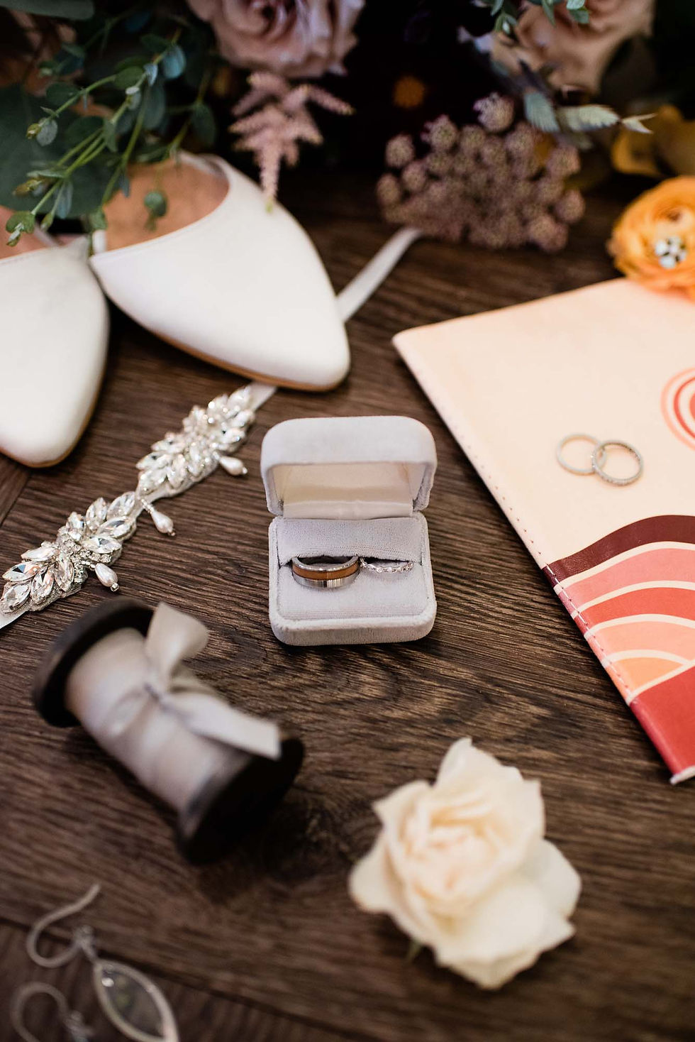 Close up of wedding ring, bridal bouquet and shoes