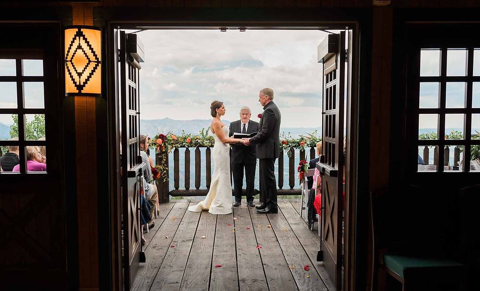 Man and woman hold hands at the altar at Cloud Camp at the Broadmoor