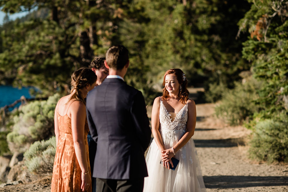 Bride and groom listen as the officiant reads during their elopement ceremony on Lake Tahoe