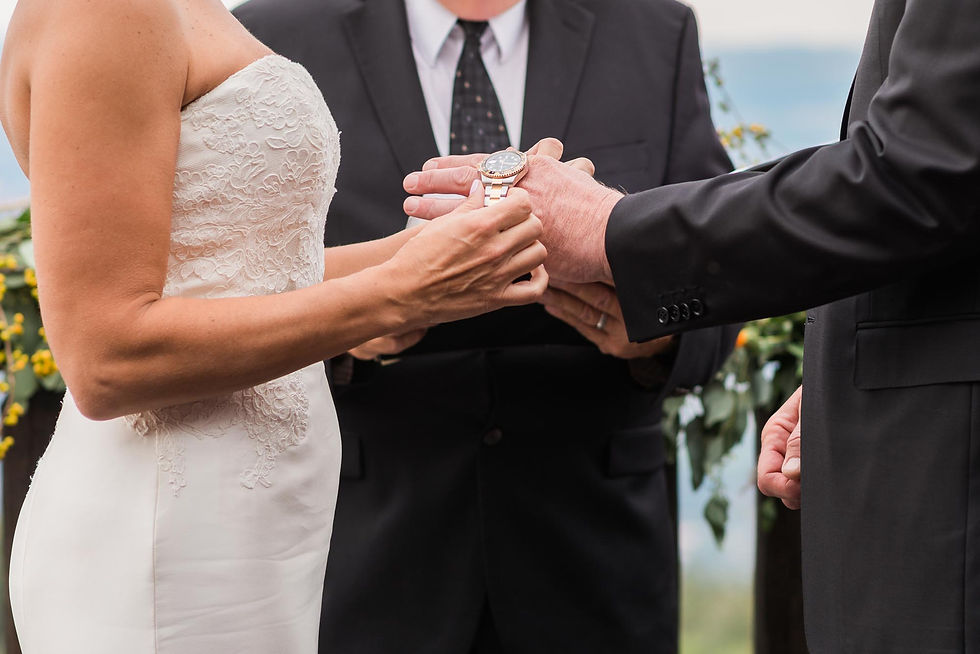 Bride places a watch on the grooms wrist at Cloud Camp at the Broadmoor