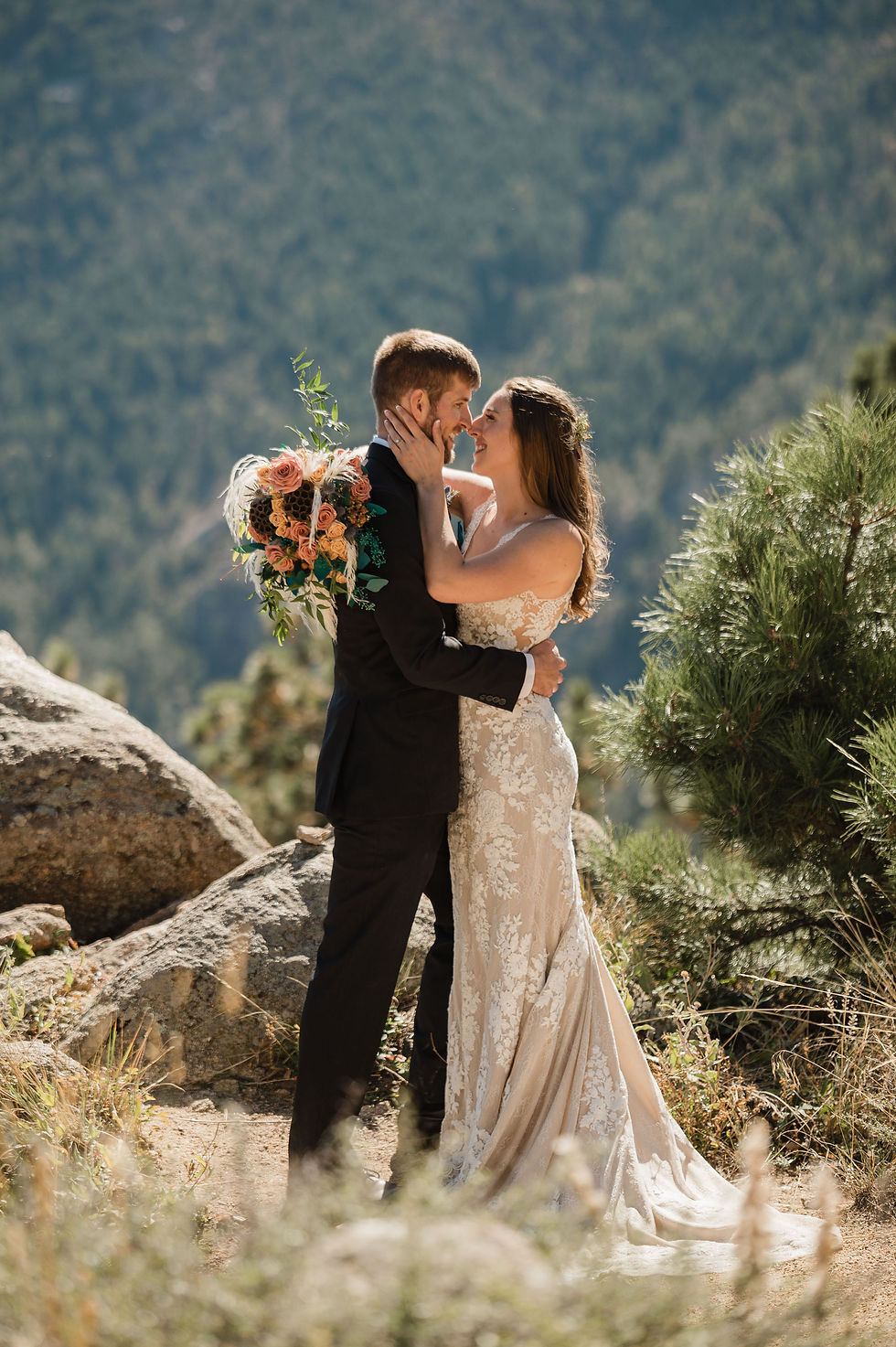 Bride and groom embrace and smile at one another