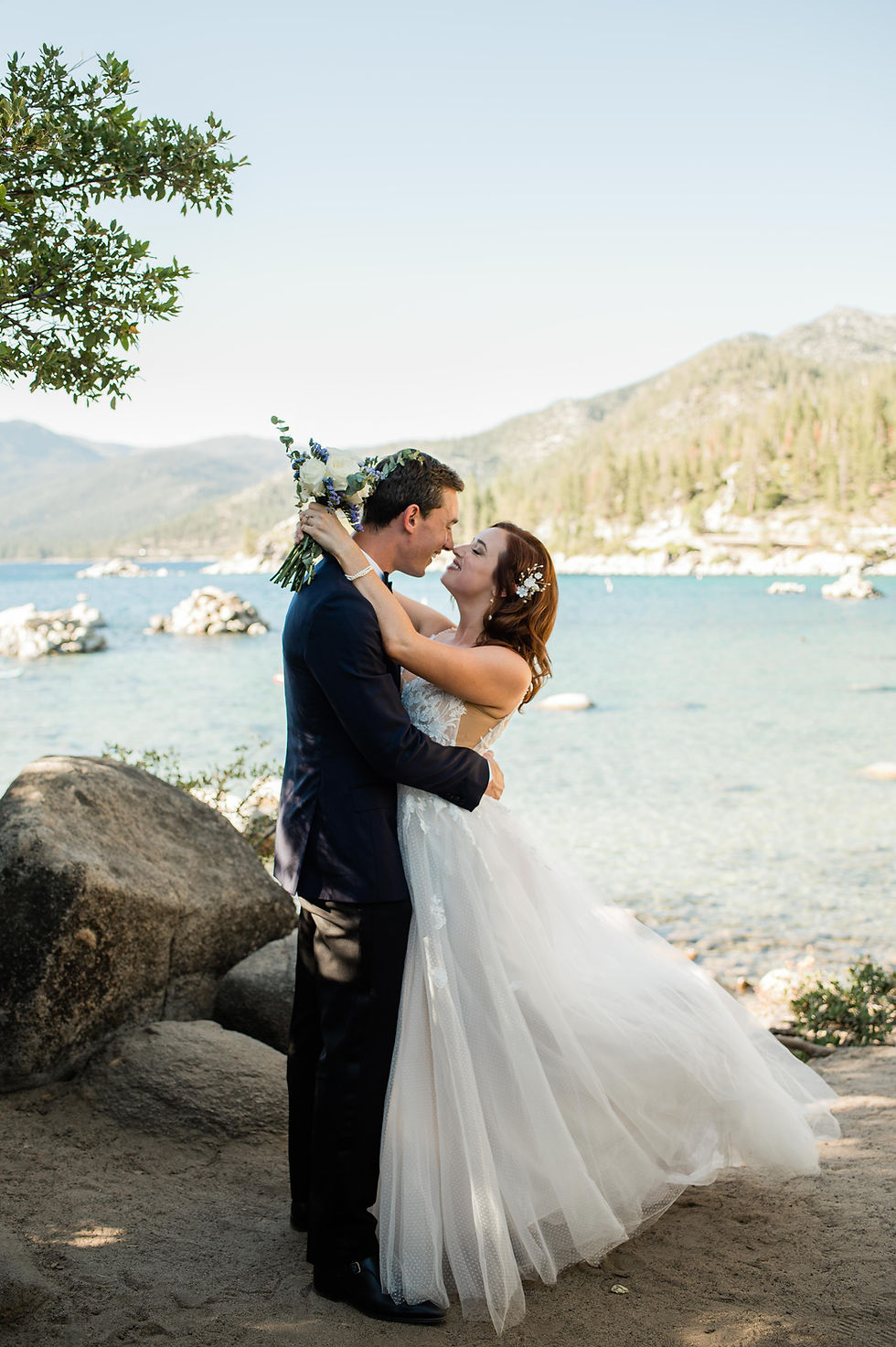 Bride and groom kiss on the shores of Lake Tahoe during elopement ceremony