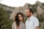 Man smiles at woman as she makes a silly face during Boulder, CO sunset engagement session