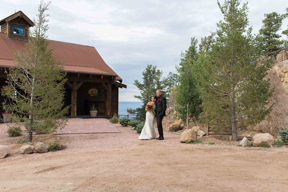 Bride and groom pose outside of Cloud Camp at the Broadmoor