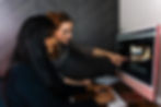 Two marketing professionals collaborating at a desk, reviewing a digital marketing agency website on a desktop computer, representing research for the Top 5 Digital Marketing Agencies in Orlando (2025)