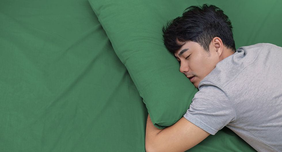 a man sleeping on a green blanket