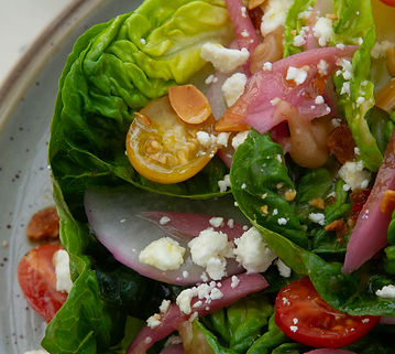 Crisp romaine salad with pickled onions, feta, cherry tomatoes, and almonds from the lunch menu at Gather 22 Indianapolis.