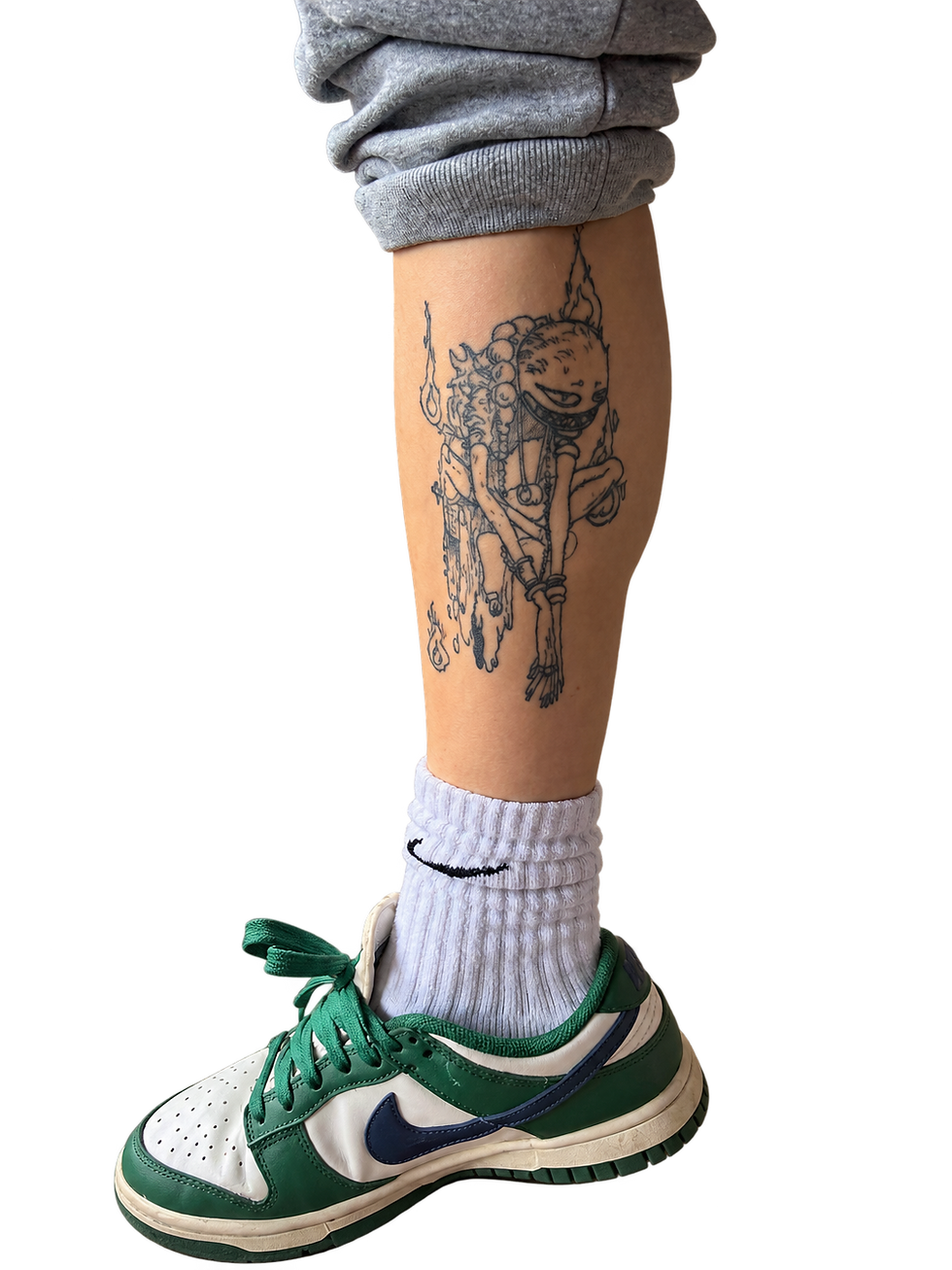 Tattooed Leg in Rolled Gray Pants.png