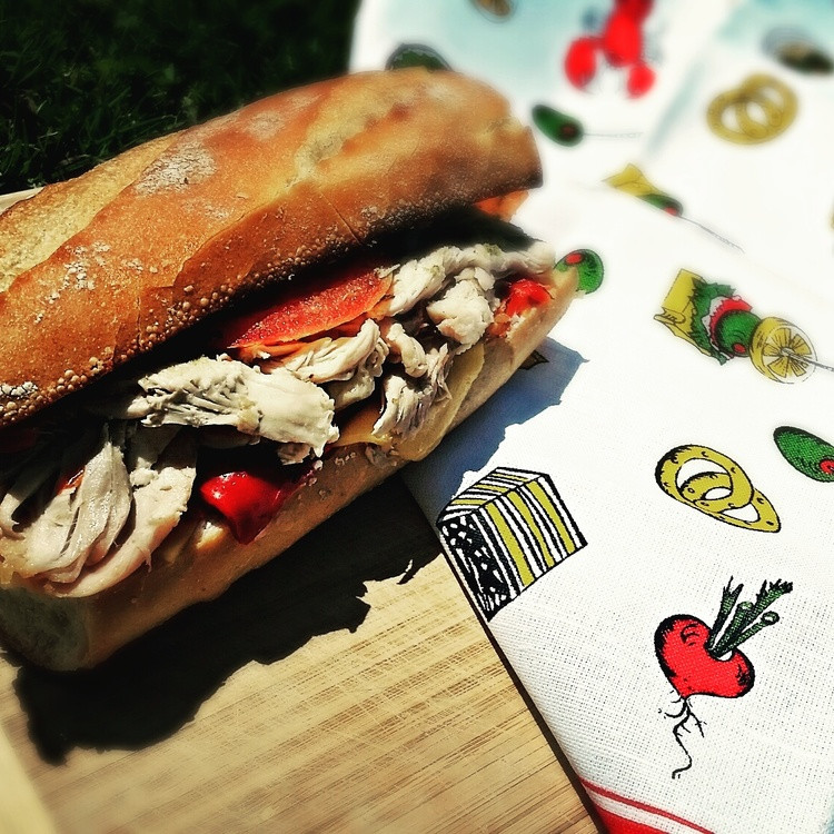 Baguette sandwich with roasted chicken, on a vintage tablecloth