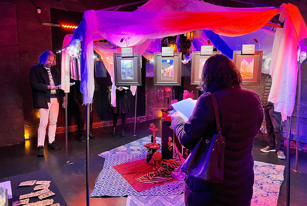 Gallery show of Mindscapes Tarot artwork by artist John A Rice with guests viewing the oil pastel art. The mood of the gallery is mystical, spiritual, and metaphysical.