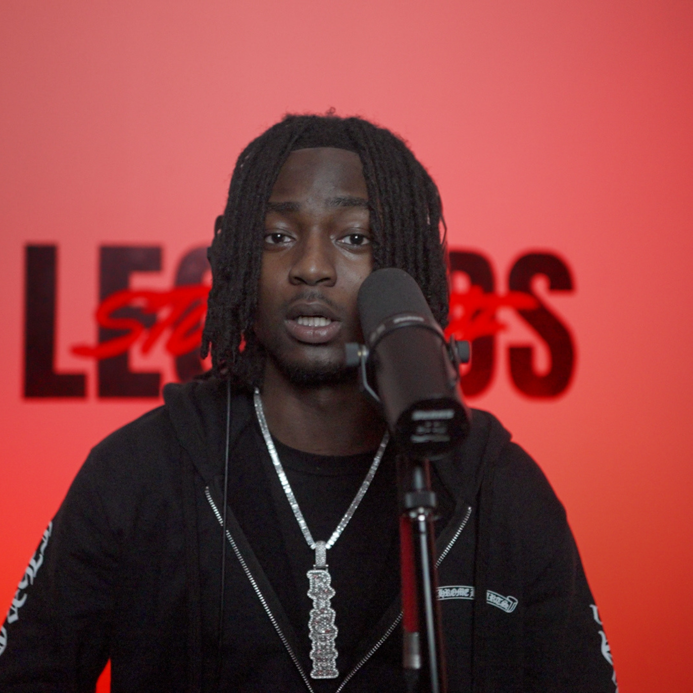 Artist performing at a Studio of Legends Open Mic microphone