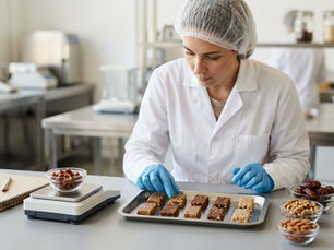 Food technologist comparing trial samples to optimize food formulations for commercial production in Lebanon