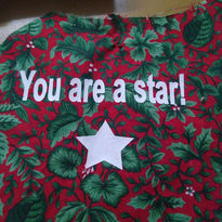 Red fabric with floral design and the words 'You are a star!'