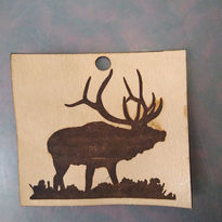 Silhouette elk wood carving art with a hole, standing in grass