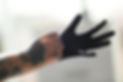 man-with-tattoo-wearing-black-latex-gloves-blurred-background.jpg