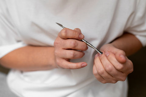 close-up-hand-holding-nail-tool.jpg