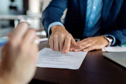 closeup-financial-advisor-pointing-place-signature-contract.jpg