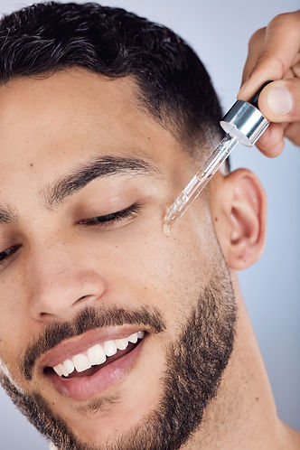 Skincare, man and facial oil for beauty with natural glow or shine results in studio. Male