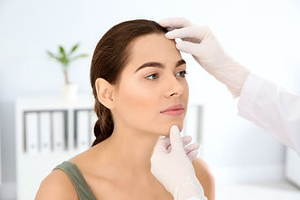 Dermatologist examining patient's face in clinic. Skin cancer checkup.jpg