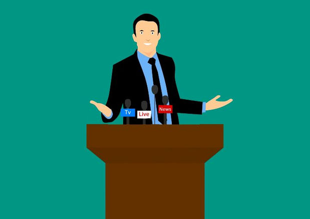 a man is giving a speech at a podium with microphones .