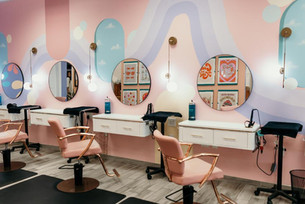 jovi salon Virginia beach,  Colorful hair salon with pink wavy walls, mirrors, and chic styling chairs.