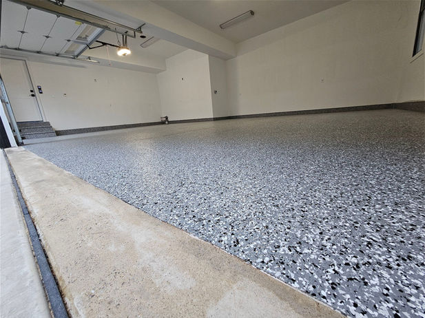 Premium 3-car residential garage floor coated with the Wombat polyaspartic flake system in Naples, FL.
