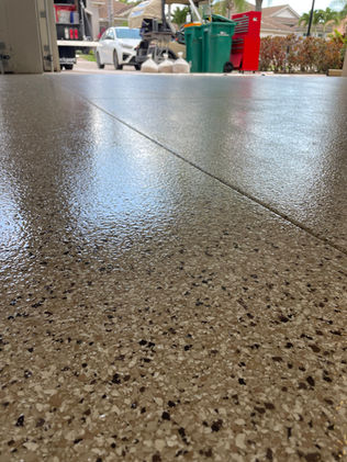 Clean expansion joints on a warm tan garage floor coating installed in Cape Coral, FL.
