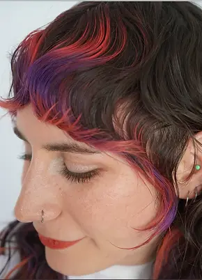 Modern textured shag haircut with custom vivid face framing highlights at our Virginia Beach hair salon.