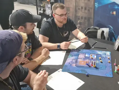 friends sit around a table playing the ttrpg Beyond the Veil