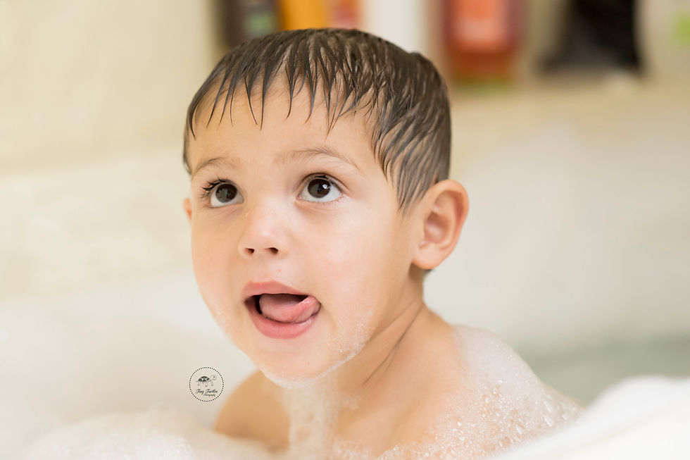 Four year old boy sticking his tongue out. Photo take by Tiny Turtles photography in San Diego CA
