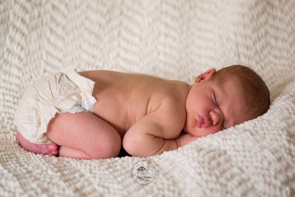 Newborn boy sleeping on cream back drop Photo taken by Tiny Turtles Photography San Diego Ca