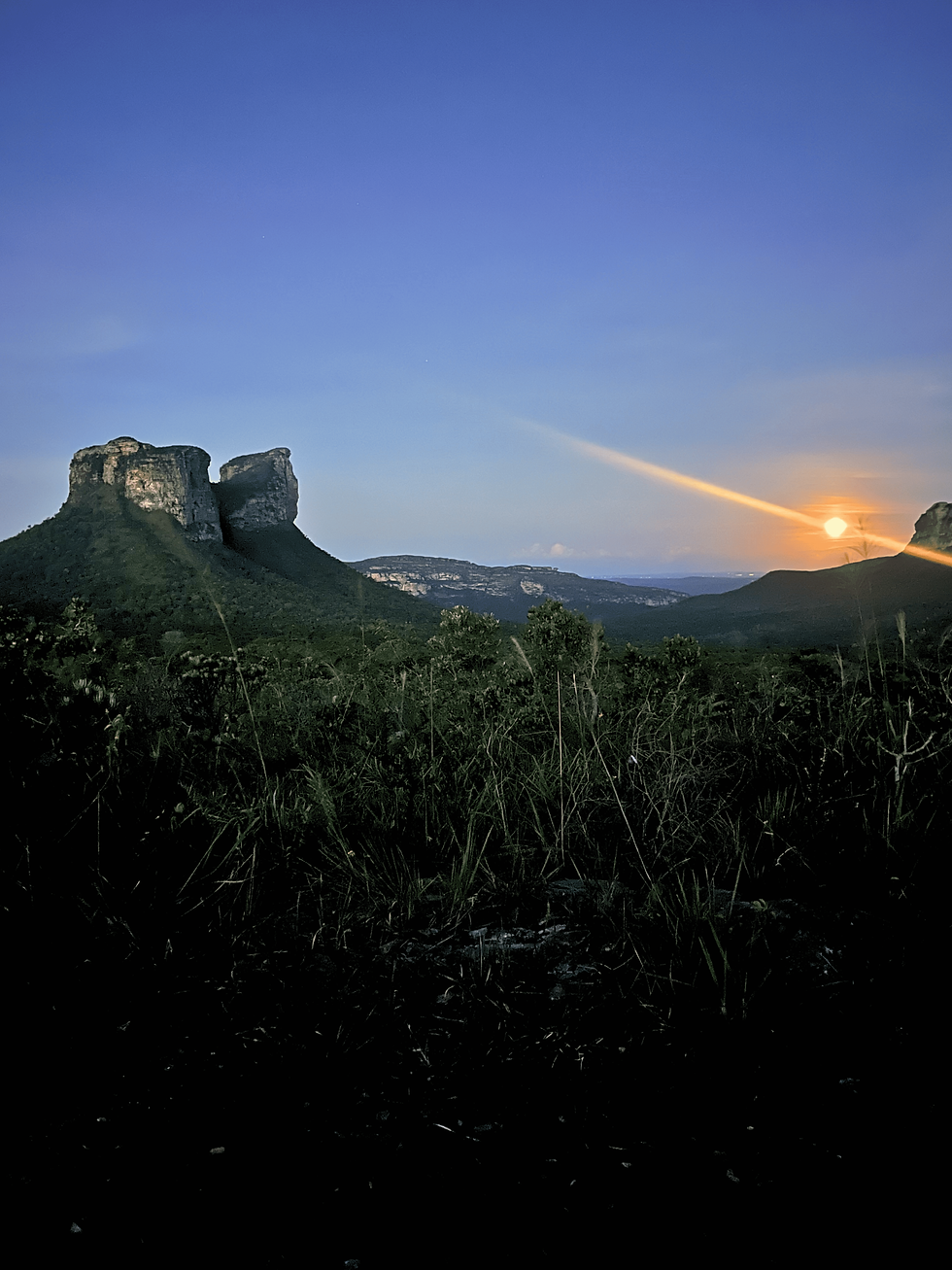 Sunset seen from Gerais do Camelo in Chapada Diamantina, with the silhouette of the tabletop mountains