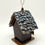 Thumbnail: Rear view of the mini birdhouse with hand-painted pinecone-scale roof and smooth black back panel.